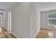 Bright hallway showcases wood flooring and natural light from the nearby windows at 113 Feezor Ct, Clayton, NC 27527
