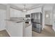Updated kitchen with stainless steel appliances, a breakfast bar, and modern white cabinetry at 113 Feezor Ct, Clayton, NC 27527