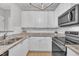 Bright kitchen featuring granite countertops, stainless steel appliances, and white cabinets at 113 Feezor Ct, Clayton, NC 27527