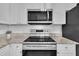 Well-lit kitchen featuring stainless steel appliances, granite countertops, and white subway tile backsplash at 113 Feezor Ct, Clayton, NC 27527