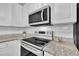 Bright kitchen featuring stainless steel appliances, white cabinets, and granite countertops at 113 Feezor Ct, Clayton, NC 27527