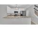 Modern kitchen with a peninsula bar, stainless steel appliances, and white cabinetry at 113 Feezor Ct, Clayton, NC 27527