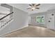 Bright living room featuring wood floors, a ceiling fan, and natural light from a window at 113 Feezor Ct, Clayton, NC 27527