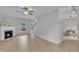 Inviting living room features a cozy fireplace, a ceiling fan, and is open to the stairs to the second floor at 113 Feezor Ct, Clayton, NC 27527