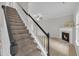 Carpeted staircase with a white railing and black accents leading to the upper level at 113 Feezor Ct, Clayton, NC 27527