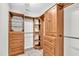 Organized walk-in closet featuring wooden shelving and drawers for ample storage at 113 Feezor Ct, Clayton, NC 27527
