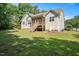Large, grassy backyard with mature trees and a screened-in porch at 120 Tanager Farms Dr, Youngsville, NC 27596