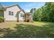 Expansive backyard with lush green lawn and a screened in porch at 120 Tanager Farms Dr, Youngsville, NC 27596