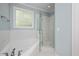 Luxurious bathroom has a soaking tub, a glass-enclosed shower and tile floors at 120 Tanager Farms Dr, Youngsville, NC 27596