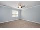 Comfortable bedroom has neutral carpet, a ceiling fan, and a window for natural light at 120 Tanager Farms Dr, Youngsville, NC 27596