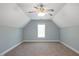 Upstairs bedroom with vaulted ceilings, neutral carpeting and a ceiling fan at 120 Tanager Farms Dr, Youngsville, NC 27596