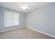 Comfortable bedroom has neutral carpet, a ceiling fan, and a window for natural light at 120 Tanager Farms Dr, Youngsville, NC 27596