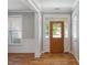 Inviting foyer with wood floors, elegant trim, and a front door with sidelights at 120 Tanager Farms Dr, Youngsville, NC 27596