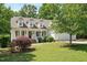Charming exterior featuring a well-maintained lawn, covered porch, and attached garage at 120 Tanager Farms Dr, Youngsville, NC 27596
