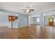 Open-concept living room with wood floors, seamlessly connecting the kitchen, dining, and foyer at 120 Tanager Farms Dr, Youngsville, NC 27596