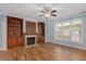 Cozy living room features built-in bookshelves, fireplace, and plenty of natural light at 120 Tanager Farms Dr, Youngsville, NC 27596