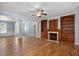 Spacious living room with a fireplace, built-in bookshelves, and wood floors at 120 Tanager Farms Dr, Youngsville, NC 27596