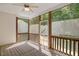 Relaxing screened-in porch with wood flooring, ceiling fan, and views of the lush greenery at 120 Tanager Farms Dr, Youngsville, NC 27596