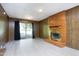 Basement with brick fireplace, wood-paneled walls, vinyl flooring, and sliding glass door at 1209 Landon St, Durham, NC 27703