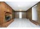 Spacious basement area with brick fireplace, wood-paneled walls, and vinyl floors at 1209 Landon St, Durham, NC 27703