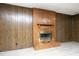 Basement featuring a brick fireplace and wood-paneled walls at 1209 Landon St, Durham, NC 27703
