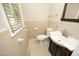 Cozy bathroom featuring tile accents, a toilet, and a vanity with storage at 1209 Landon St, Durham, NC 27703