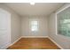 Comfortable bedroom featuring hardwood floors, neutral walls, and bright natural light at 1209 Landon St, Durham, NC 27703