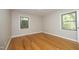 Bright bedroom with hardwood floors and natural light from two windows at 1209 Landon St, Durham, NC 27703