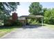 Exterior backyard view of a brick home with an attached covered parking area at 1209 Landon St, Durham, NC 27703