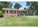 Charming single-story brick home featuring a well-maintained lawn and mature trees at 1209 Landon St, Durham, NC 27703