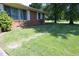 View of the front yard with stone pavers creating a walkway around the house at 1209 Landon St, Durham, NC 27703