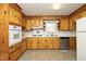 Eat-in kitchen features wood cabinets, linoleum flooring, and stainless steel appliances at 1209 Landon St, Durham, NC 27703