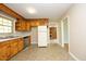 Cozy kitchen featuring wood cabinets, stainless steel appliances, and linoleum flooring at 1209 Landon St, Durham, NC 27703
