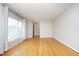 Bright living room with hardwood floors, neutral walls, and large windows with sheer curtains at 1209 Landon St, Durham, NC 27703