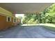 Covered parking area attached to a brick home, with views of the backyard at 1209 Landon St, Durham, NC 27703