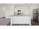 Contemporary kitchen showcasing granite countertops, stainless steel appliances, and white cabinetry at 1249 Pond Overlook Drive, Nashville, NC 27856