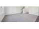 Spacious living room with gray carpet, white walls, and staircase to second floor at 1249 Pond Overlook Drive, Nashville, NC 27856
