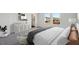 Bright and airy main bedroom with two windows, stylish dresser, and ensuite bathroom access at 1249 Pond Overlook Drive, Nashville, NC 27856
