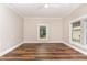 Bedroom with wood floors, and two windows providing natural light at 1398 Tarboro Rd, Youngsville, NC 27596