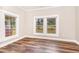 Bedroom featuring wood floors and large windows offering views of the landscape at 1398 Tarboro Rd, Youngsville, NC 27596