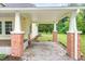 Attached carport with brick pillars and white trim, offering sheltered parking and side yard access at 1398 Tarboro Rd, Youngsville, NC 27596