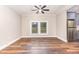 Open dining area with wood floors, ceiling fan, and a view of the backyard through a large window at 1398 Tarboro Rd, Youngsville, NC 27596