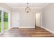 Dining room with wood floors, white trim, and natural light from the sliding doors leading to the backyard at 1398 Tarboro Rd, Youngsville, NC 27596