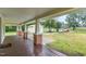 Spacious front porch with wood flooring, brick columns, and a welcoming entry to the home at 1398 Tarboro Rd, Youngsville, NC 27596