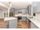 Charming kitchen featuring granite countertops, stainless appliances, gray cabinets, and stylish pendant lighting at 1398 Tarboro Rd, Youngsville, NC 27596
