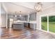 Modern kitchen with stainless steel appliances, granite countertops, and a sliding glass door to the backyard at 1398 Tarboro Rd, Youngsville, NC 27596