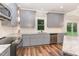 Bright kitchen with granite counters, stainless steel appliances, gray cabinets and view to the backyard at 1398 Tarboro Rd, Youngsville, NC 27596