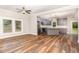 Open concept living space with wood floors, natural light, and a seamless transition to the kitchen at 1398 Tarboro Rd, Youngsville, NC 27596