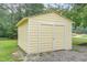 Yellow metal shed with double doors and a gravel pad at 1398 Tarboro Rd, Youngsville, NC 27596