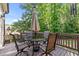 Outdoor dining area on the back deck with a round glass table, chairs, and a patio umbrella at 1412 Wakefield Farm Rd, Zebulon, NC 27597